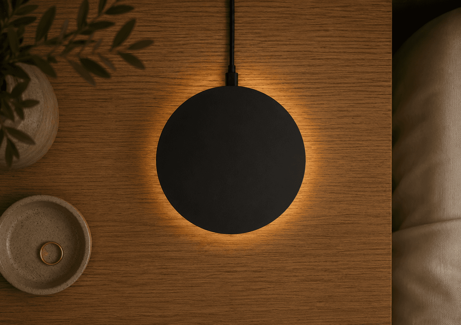 Top-down view of the Dormio device glowing on a bedside table